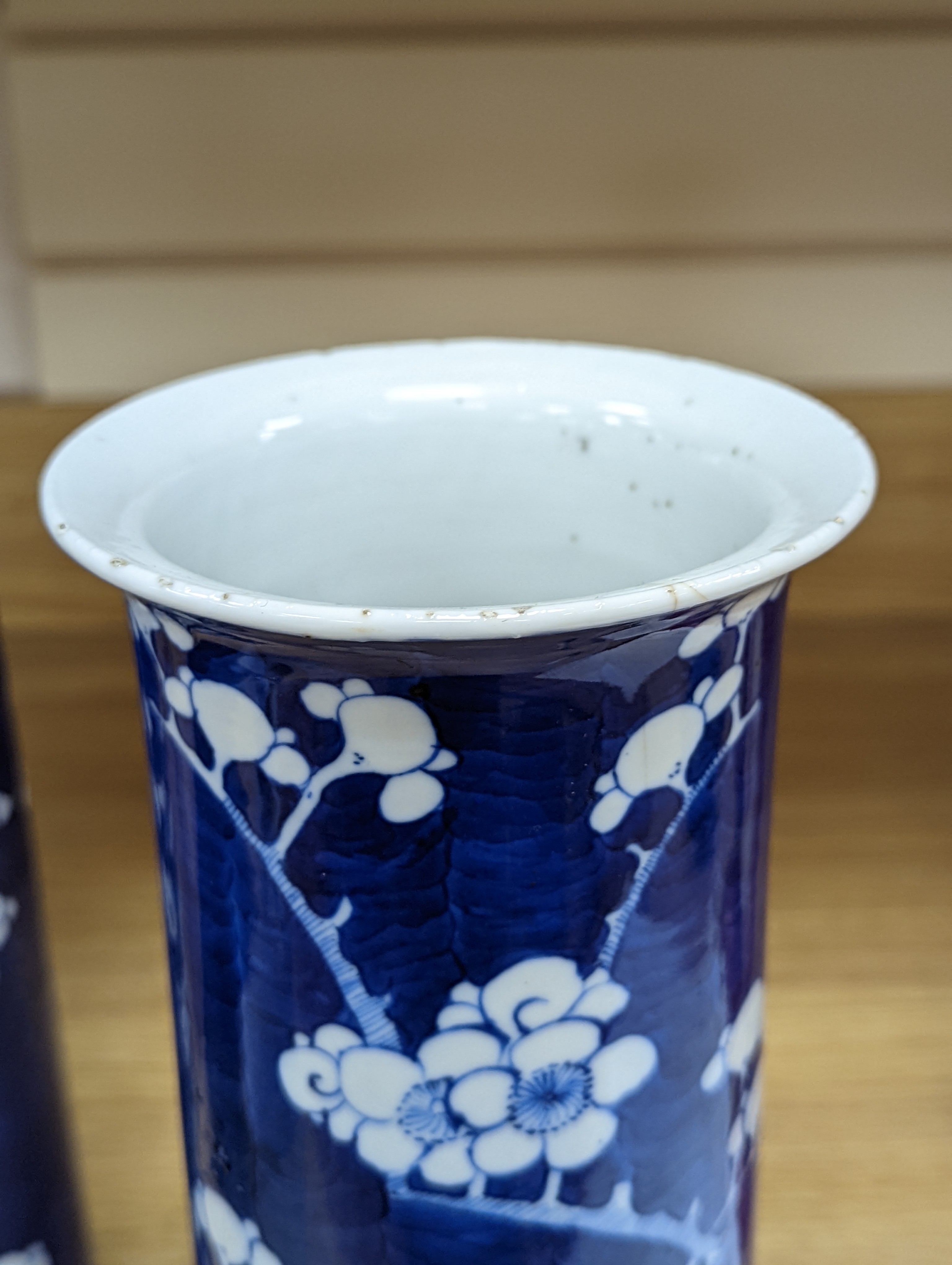 An 18th century Chinese famille rose mug, a Chinese Imari tea caddy and two Chinese blue and white sleeve vases 30cm (4)